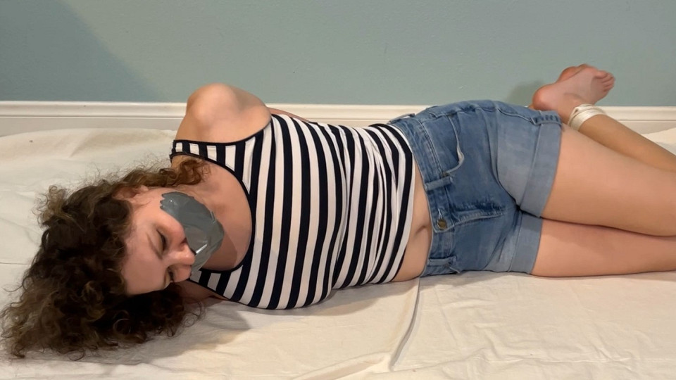 Nikki hogtied and tape gagged on the floor